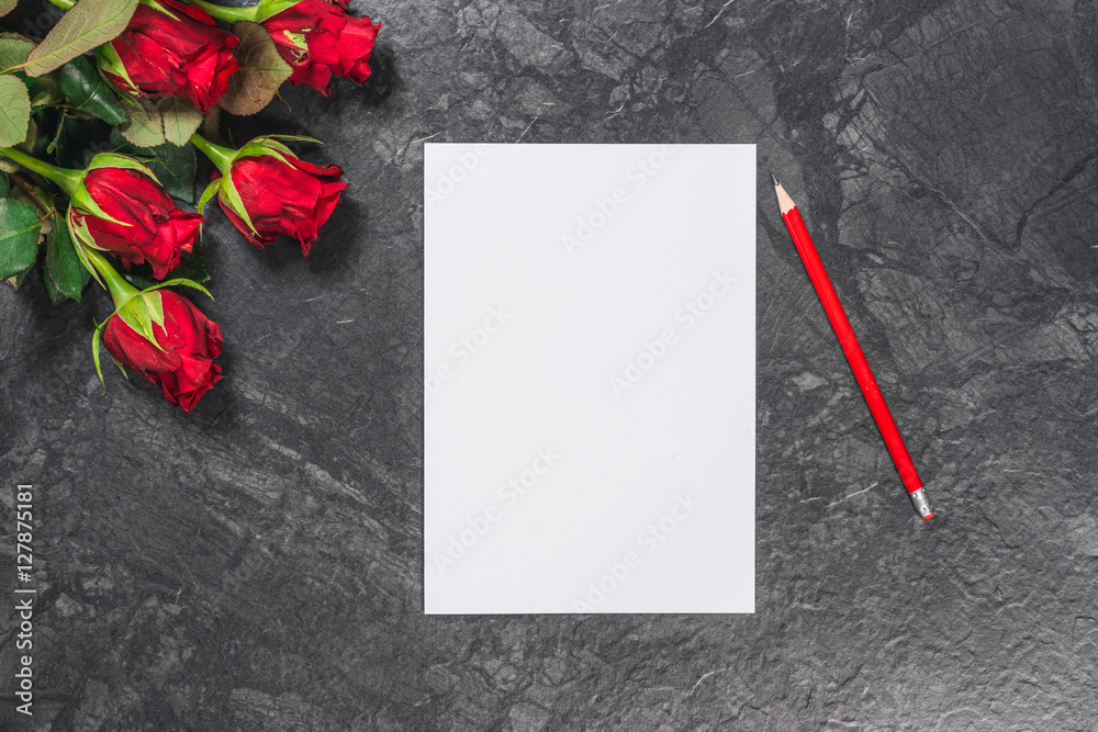 Sheet of paper, pen and red roses on black table. Valentines Day background.