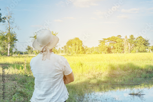 Thailand farmer woman is looking her farm. lens flare sunshine effect. photo