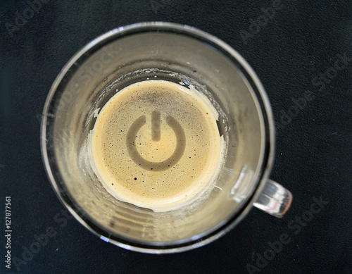 Coffee with the symbol of the power button drawn in the cream