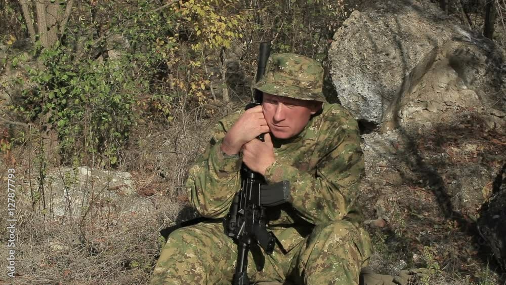 Automatic rifle and Adult Soldier in camouflage Automatic rifle and Adult Soldier in camouflage
