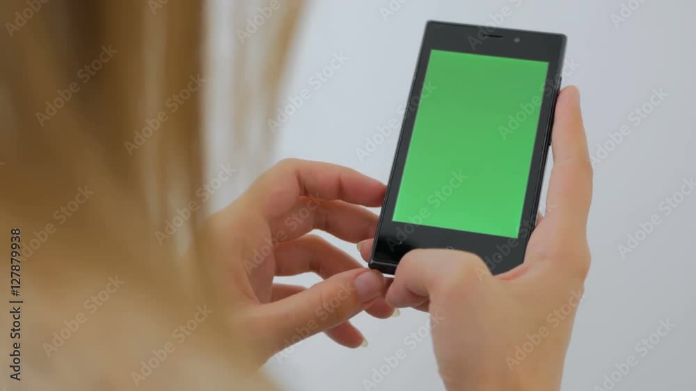 Woman using vertical smartphone with green screen. Close up shot of woman's hands with mobile Close up shot of woman's hands with mobile. White background Woman using vertical smartphone with green screen. Close up shot of woman's hands with mobile Close up shot of woman's hands with mobile. White background