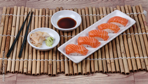 Japanese food - salmon sushi served with side dish.