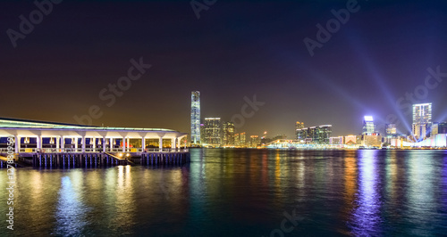 Hong Kong skyscrapers at night with boats in movement