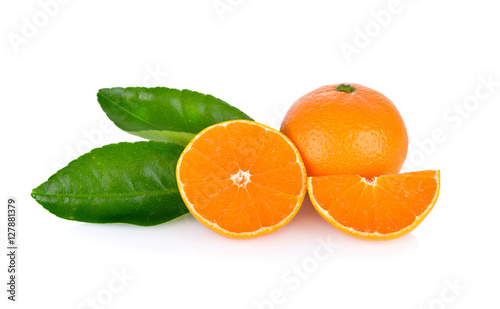 whole and cut ripe orange with leaf on white background