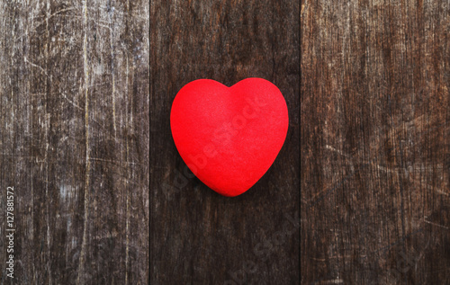 red heart on old wood background texture