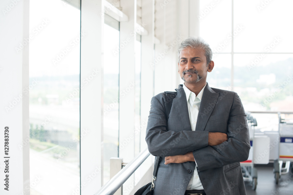matured indian business male walking at airport matured indian business male walking at airport