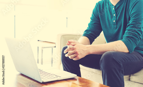 Man on a laptop in bright room
