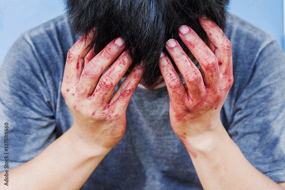 Fototapeta premium Bloody theme lone murderer: the murderer shows bloody hands and