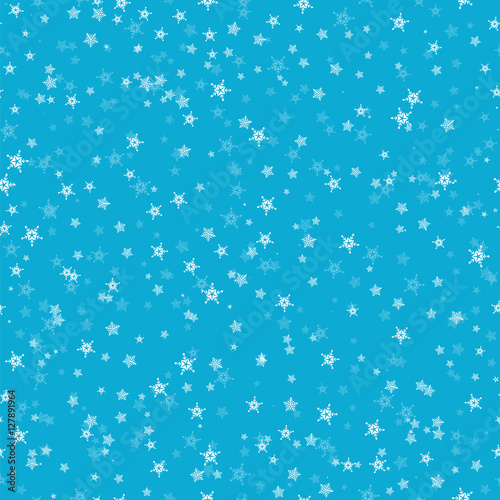 Seamless pattern of many snowflakes on blue background. Christma