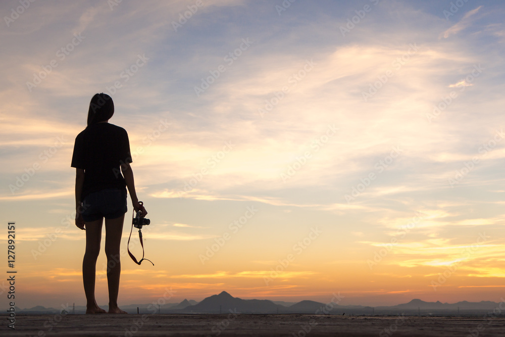 Girl photographer with camera at sunset Girl photographer with camera at sunset