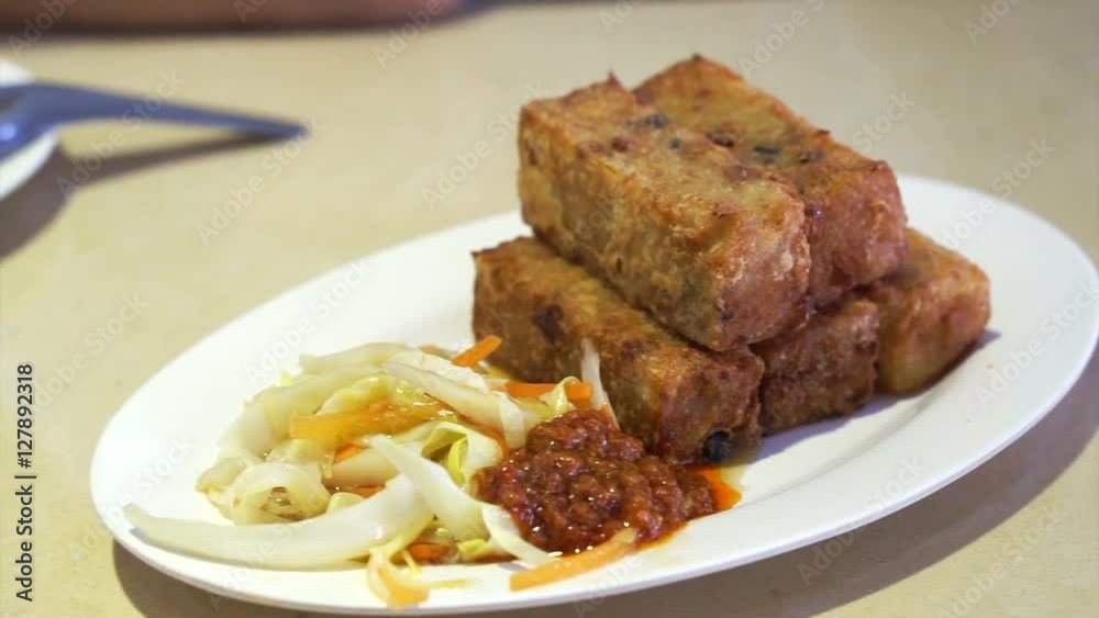 Fried turnip cake with chili sauce and vegetable Fried turnip cake with chili sauce and vegetable