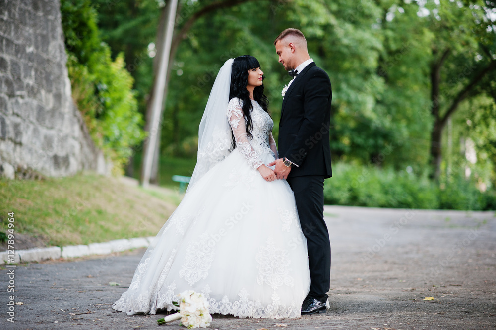Delectable wedding couple stay hugging on park. Delectable wedding couple stay hugging on park.
