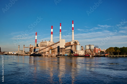 NEW YORK CITY - SEPTEMBER 27, 2016: Ravenswood Generating Station with red and white striped chimneys, seen from Roosevelt Island