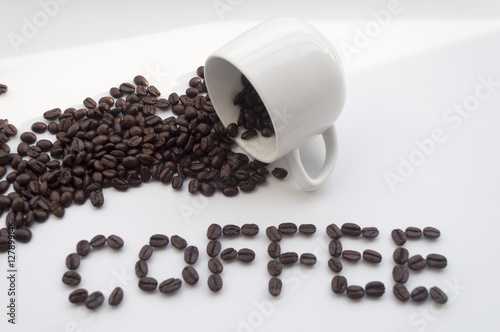 isolated white cup of coffee and coffee beans on white backgroun