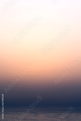 Tranquil and serene sunset at the sea or ocean. Colorful gradient