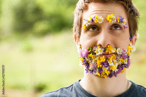 portrait of a guy with flowers instead of his beard photo