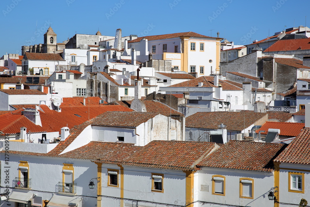 EVORA, PORTUGAL: View of the white houses with their tiled roofs (Santo Antao church in the background)