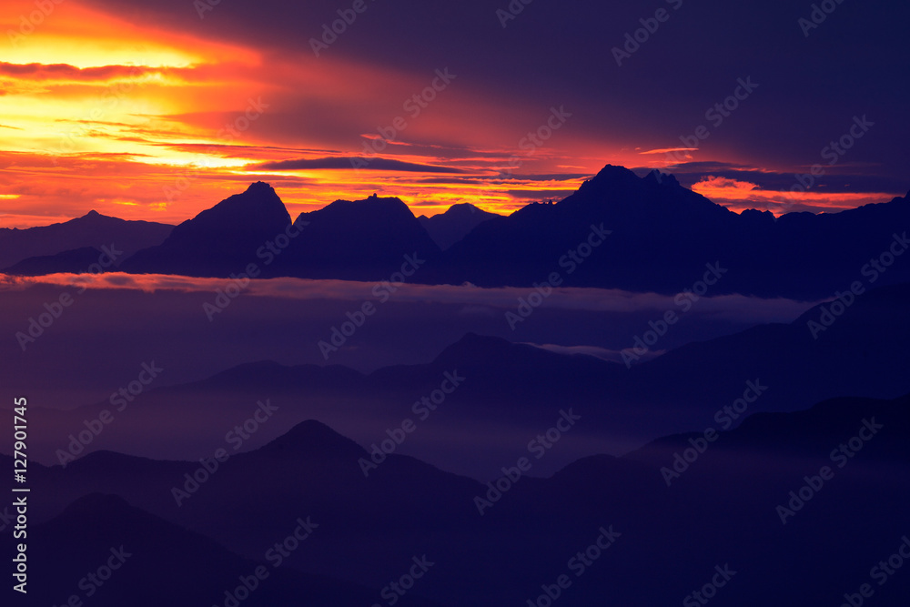 Santa Marta Mountain, Colombia. Looking down on Sierra Nevada de Santa Marta, high Andes mountains of the Cordillera, Colombia. Beautiful landscape with sun during sunset. Fog and clouds in the rock.