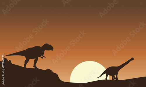 Silhouette of mapusaurus and argentinosaurus scenery photo