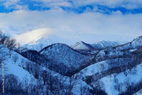 Rausu is mountain located in Menashi District, Nemuro Subprefecture, Hokkaido. Rausu harbour morning sunset during winter. Beautiful winter landscape from Japan. Snow in the town Rausu, end of night. photo