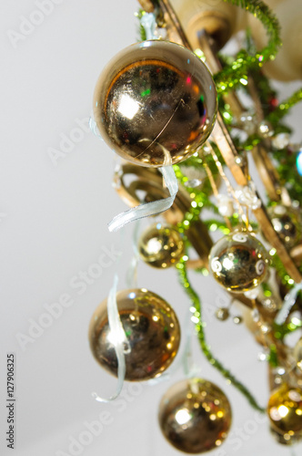 Look from below at golden balls hanging from the lamp