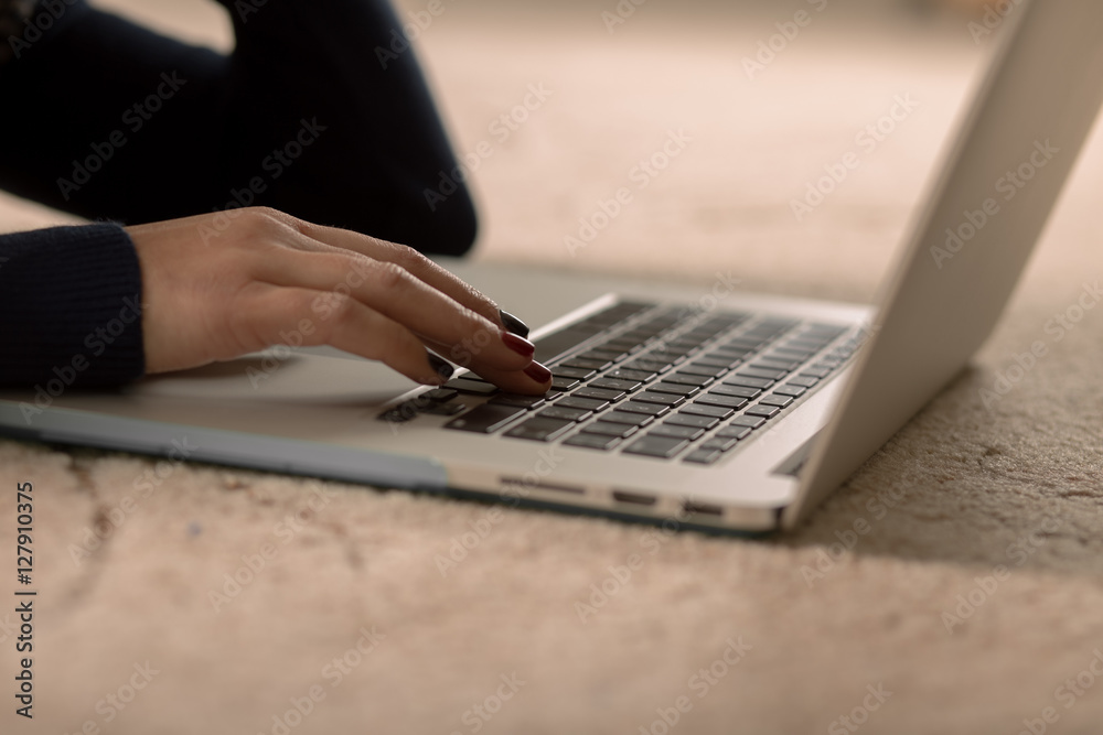 Closeup of a woman's hand working on laptop Closeup of a woman's hand working on laptop