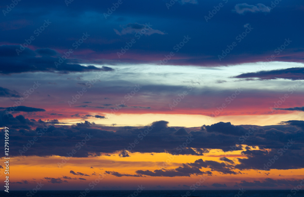 Colourful sunset with clouds and sunbeams