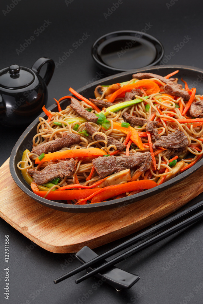 Soba noodles with veal over black background Soba noodles with veal over black background