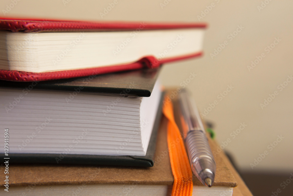 close up capture of colorful notebooks and pen close up capture of colorful notebooks and pen