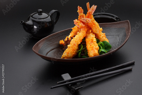 Tempura shrimp on a black plate