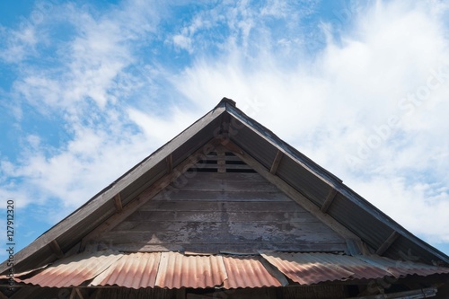 old roof of house in countryside under the blue sky