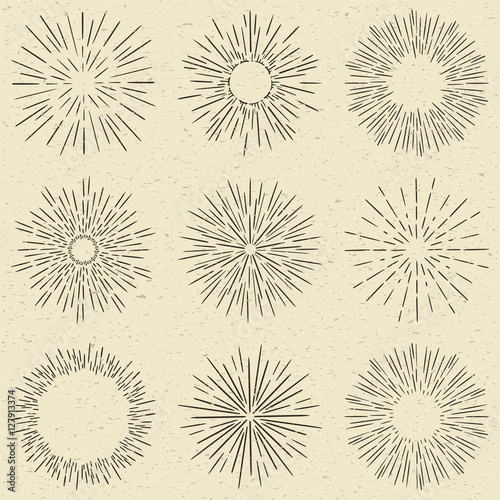 Set of hand drawn retro sunburst, fireworks or bursting rays design elements. Vintage style, grunge paper background.