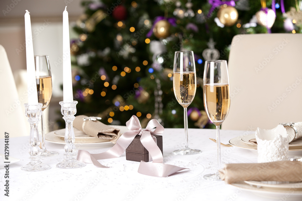 Christmas gifts on the beautiful table with Christmas tree on ba Christmas gifts on the beautiful table with Christmas tree on ba