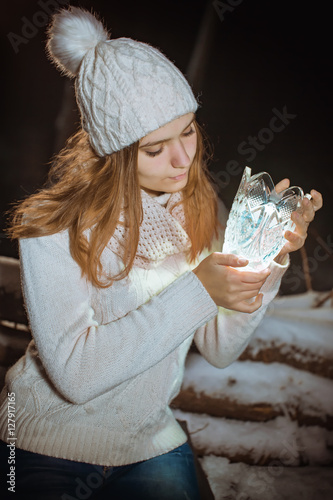 Girl holding a luminous vase © jura