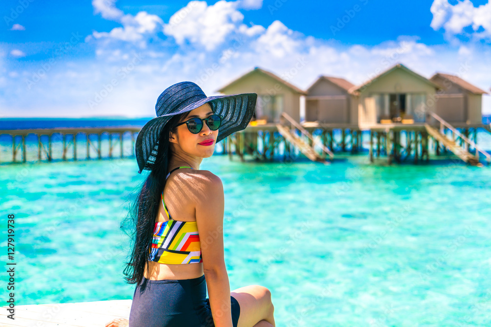 Portrait of happy young woman at beautiful water villa at Maldiv