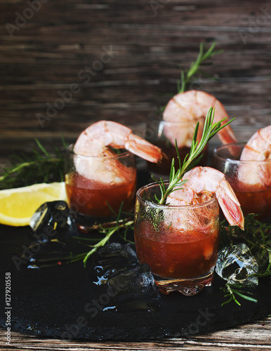 appetizer of shrimp cocktail with rosemary and sauce, selective focus