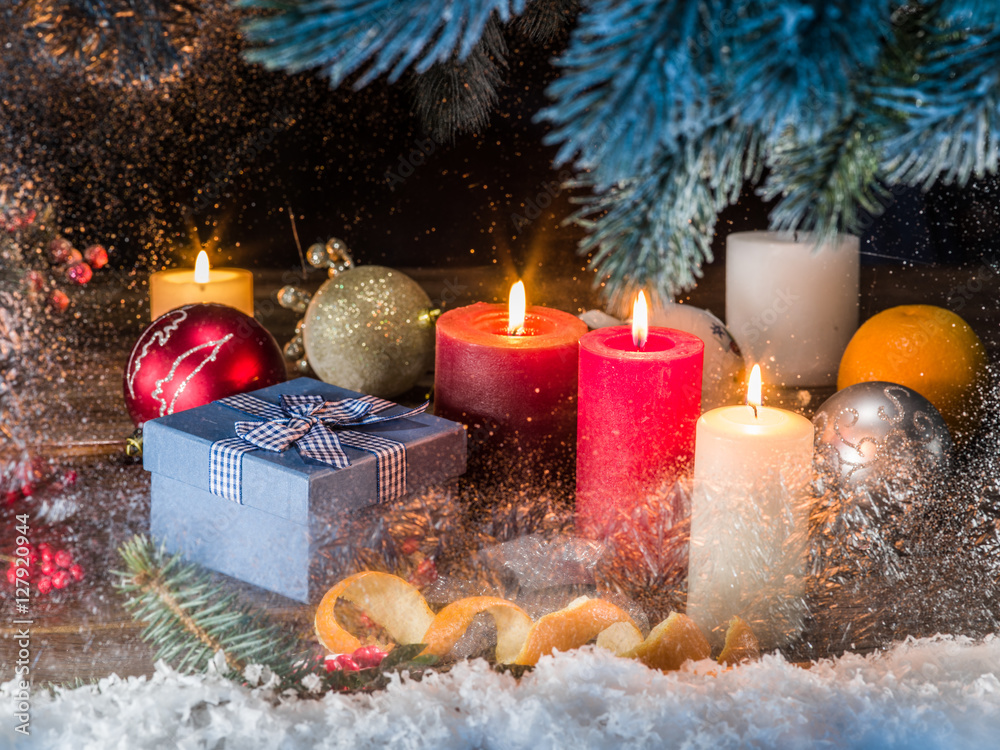 Gift boxes, candle lights and frozen window. Christmas backgroun