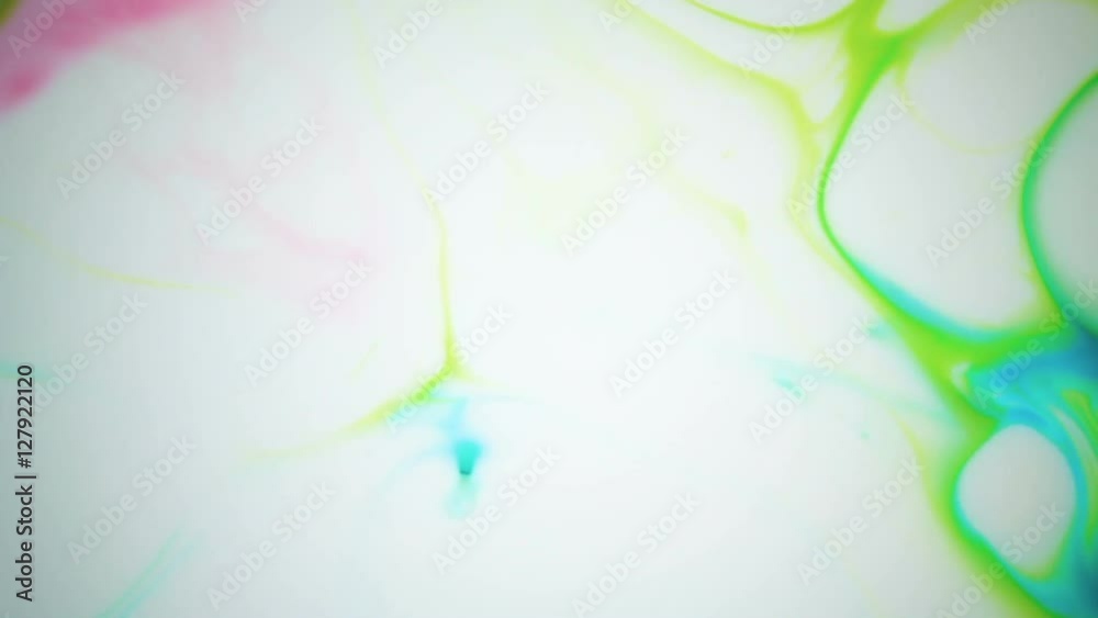 Beautiful movement of bright colors on a white background. Red, blue, green paint. Beautiful movement of bright colors on a white background. Red, blue, green paint.