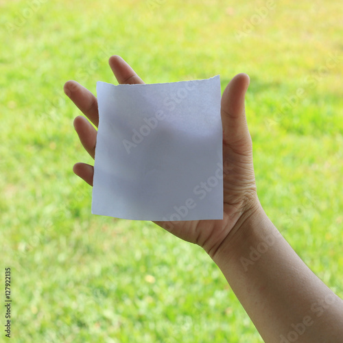 Woman hand holding a white notepaper
