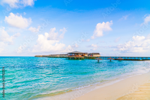 Beautiful water villas in tropical Maldives island at the sunris