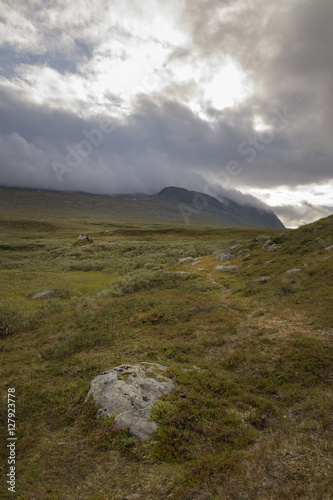 Trail leading to ancient Sami shelter in a desolate and overcast landscape