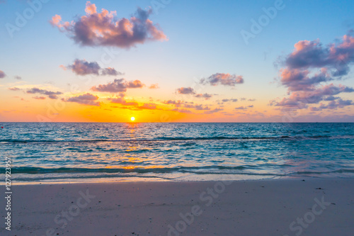 Beautiful sunset with sky over calm sea  in tropical Maldives is