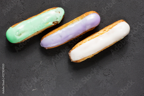 Eclairs on a black background  horizontal  top view  soft focus  