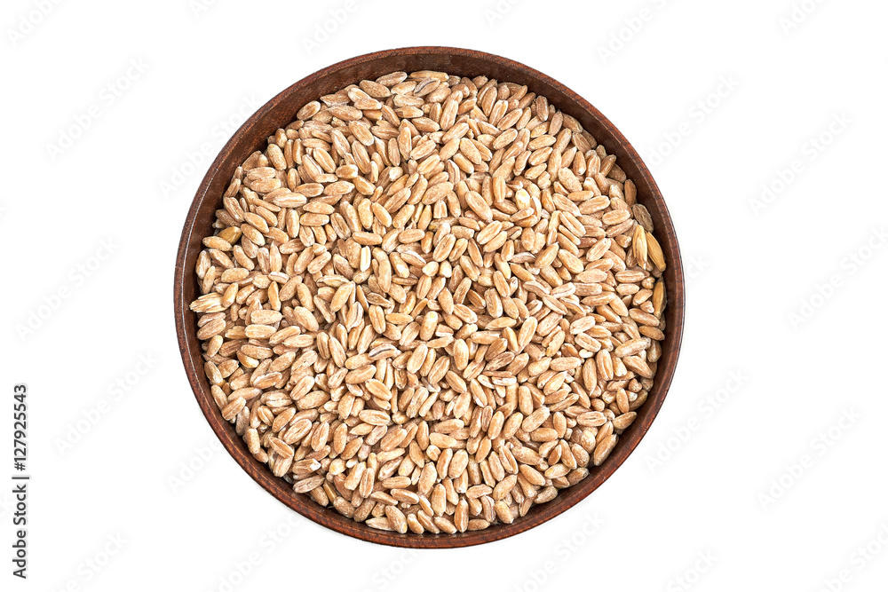 Spelt grain (dinkel wheat) in wooden bowl isolated on white background Spelt grain (dinkel wheat) in wooden bowl isolated on white background