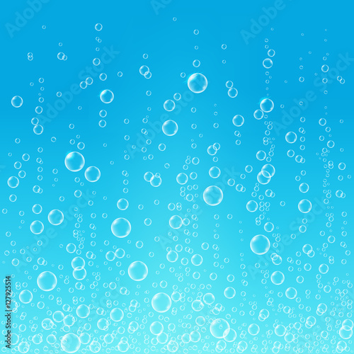 Fizzing air bubbles in water on blue background.