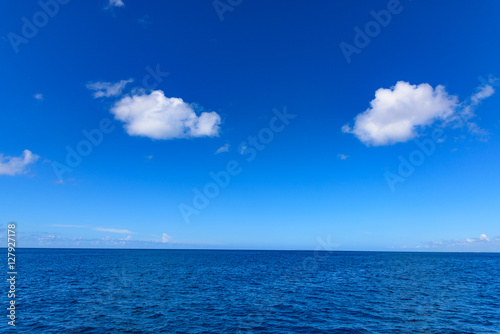 open blue sea cumulus clouds