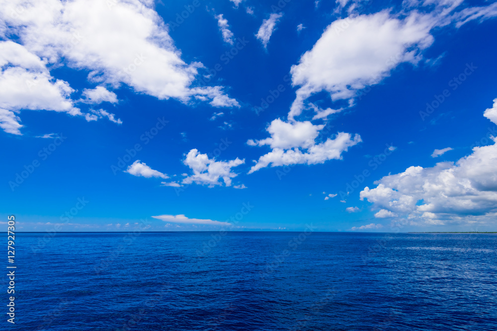 open blue sea cumulus clouds