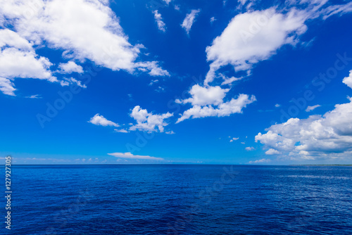 open blue sea cumulus clouds
