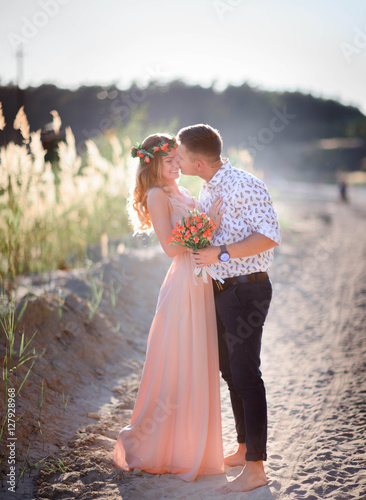 charming and young man and woman standing together on sandy path © IVASHstudio