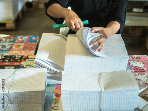 Asian women fold a piece of paper to ready to make a books in bo